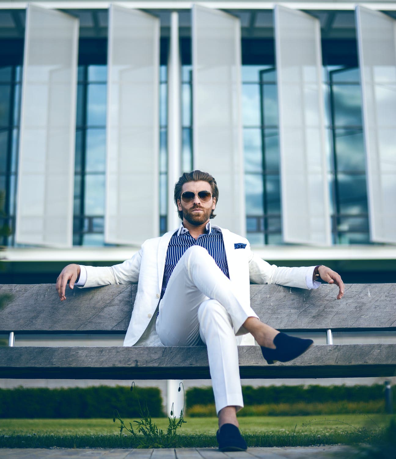 Well groomed male model in suit sat down